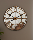 Decorative wall clock with Roman numeral markers on a plain wall.