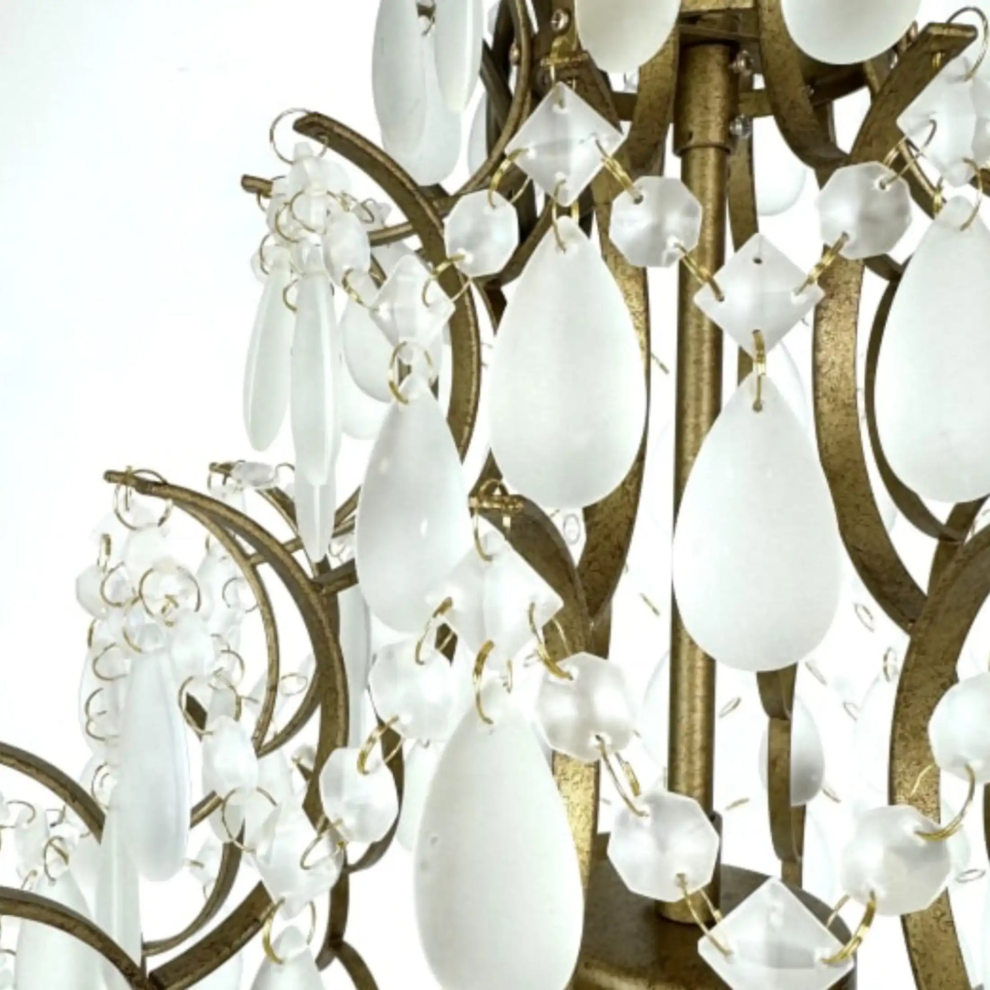 Close-up of a chandelier with white glass shades and gold metalwork.