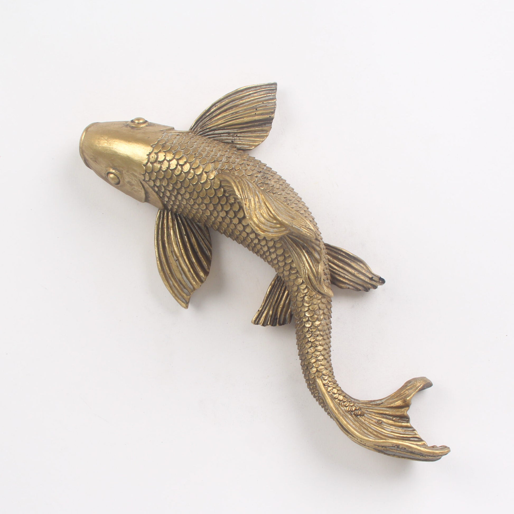 Bronze fish sculpture on a white background