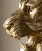Close-up of a gold tiger statue against a dark background