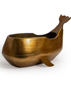 Bronze whale-shaped container on a white background