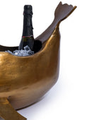 Bronze boat-shaped cooler with a bottle of champagne inside on a white background