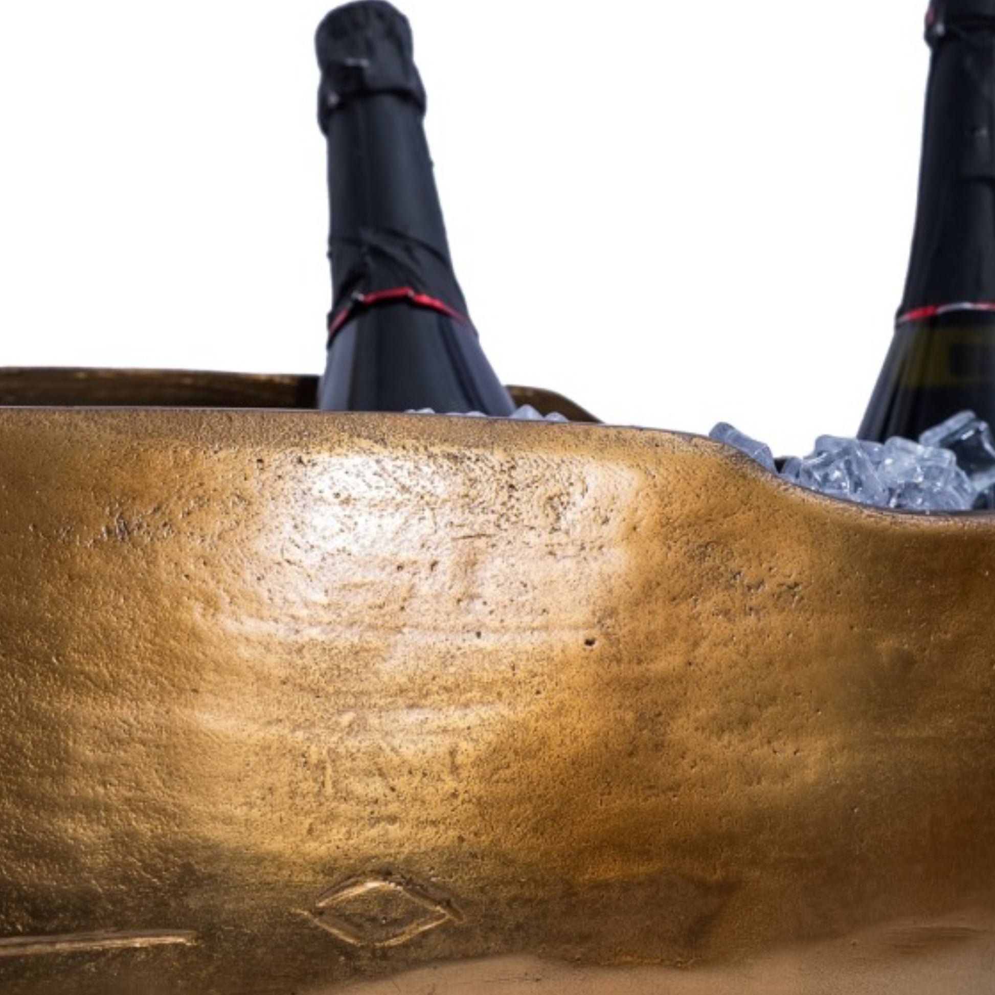Two bottles of champagne in a decorative bronze ice bucket on a white background