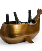 Gold whale-shaped wine cooler with bottles inside on a white background