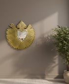 Gold decorative element with heart shape and leaf design on a white background