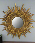 Gold sunburst mirror on a white background
