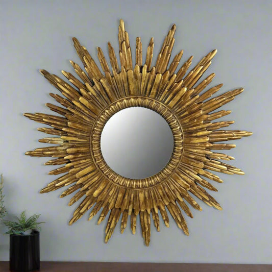 Gold sunburst mirror on a white background