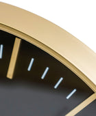Close-up of a gold-framed clock with black face and white hour markers on a white background