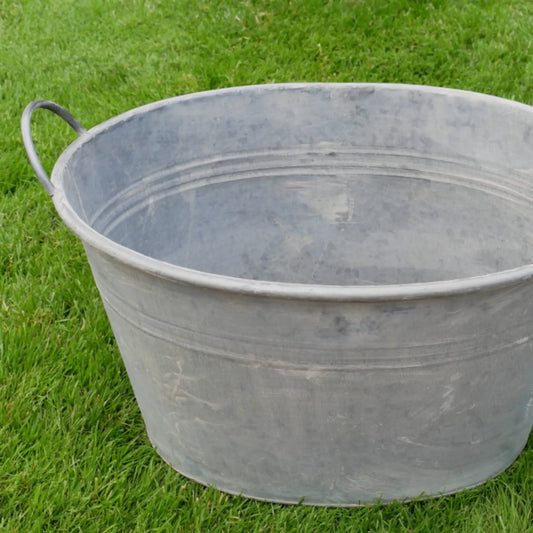 Metal basin on a grassy background