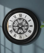 Decorative wall clock with intricate design on a blue wall