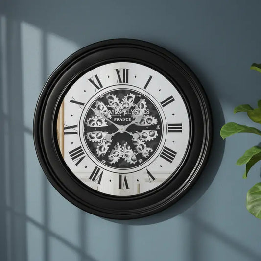Decorative wall clock with intricate design on a blue wall