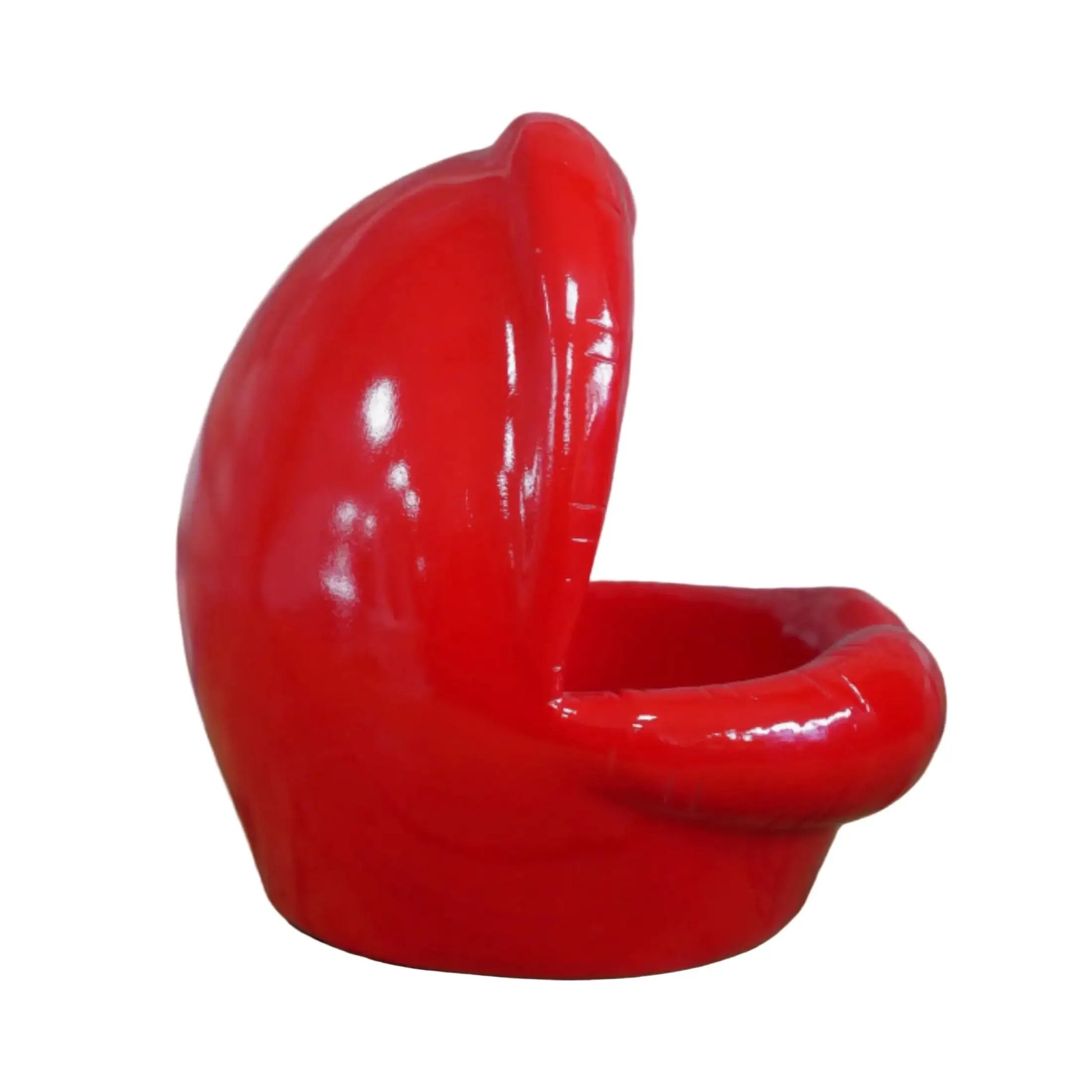 Red ceramic chair with a unique design on a wooden surface and stone wall background