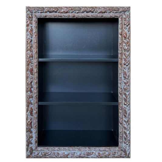 Decorative bookshelf with ornate frame on a white background