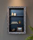 Decorative wall shelf with various items against a neutral wall
