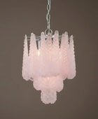 Pink glass chandelier against a brown background