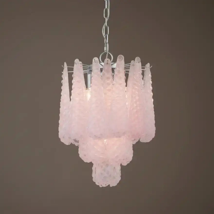 Pink glass chandelier against a brown background