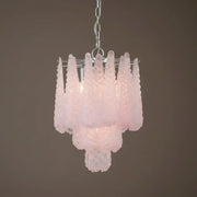 Pink glass chandelier against a brown background