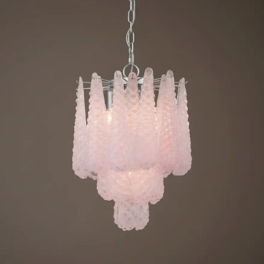 Pink glass chandelier against a brown background