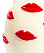 White spherical object with red lips printed on it against a white background