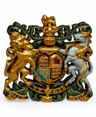 Decorative emblem with gold, green, and white colors on a white background