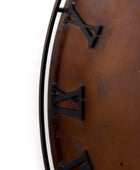 Close-up of a wooden wall clock with Roman numerals on a white background