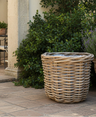 Wicker planter with plants on a patio