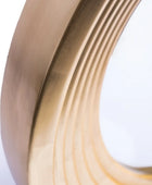 Close-up of a coiled brass strip on a white background