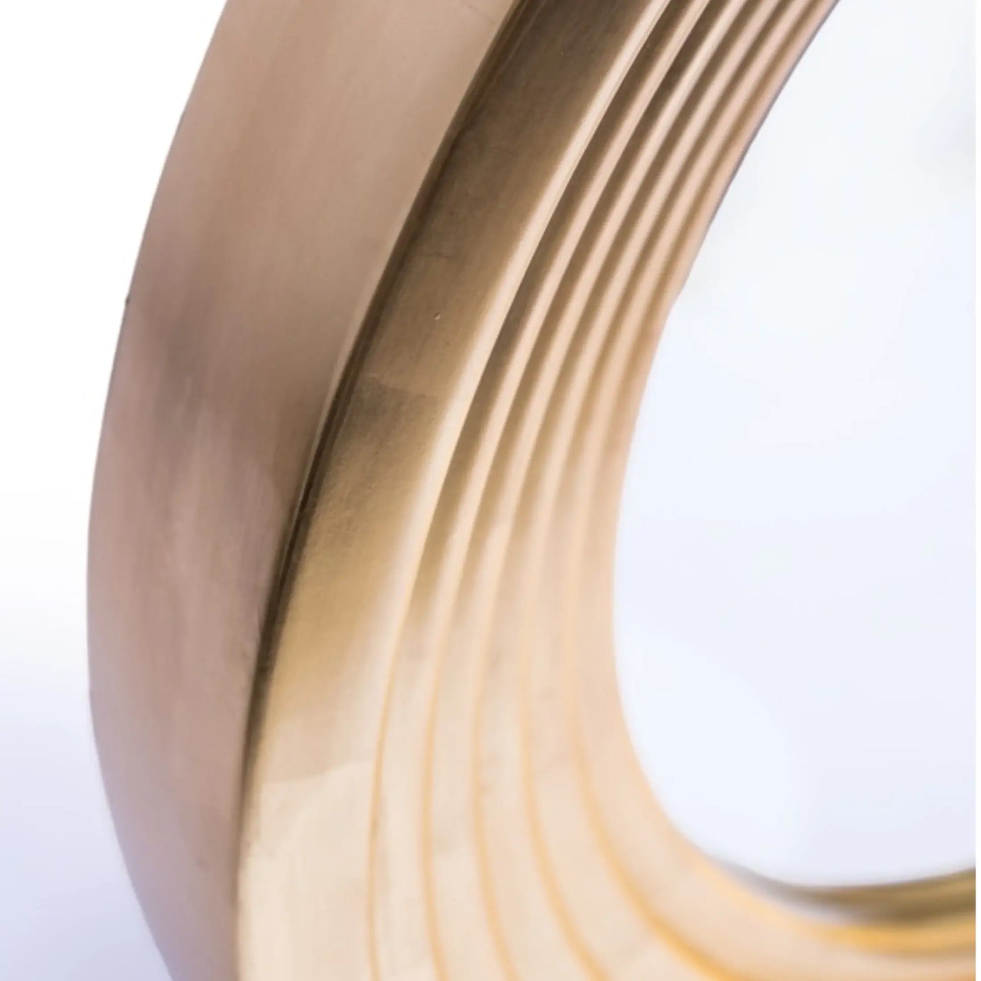 Close-up of a coiled brass strip on a white background