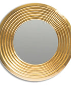Round gold-framed mirror on a white background
