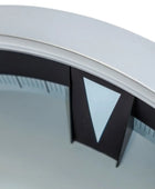 Close-up of a circular object with a black triangle and white border on a light gray background