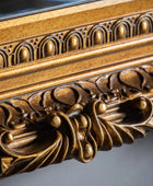 Close-up of an ornate gold frame with intricate detailing