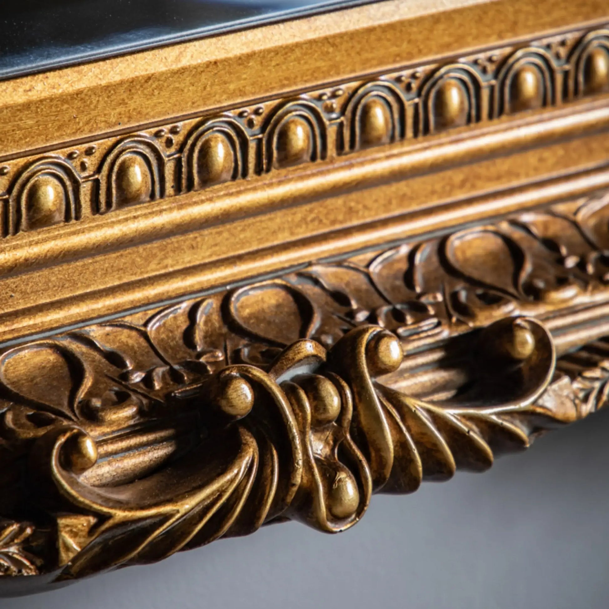 Close-up of an ornate gold frame with intricate detailing