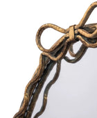 Bronze bow-shaped decorative item on a white background
