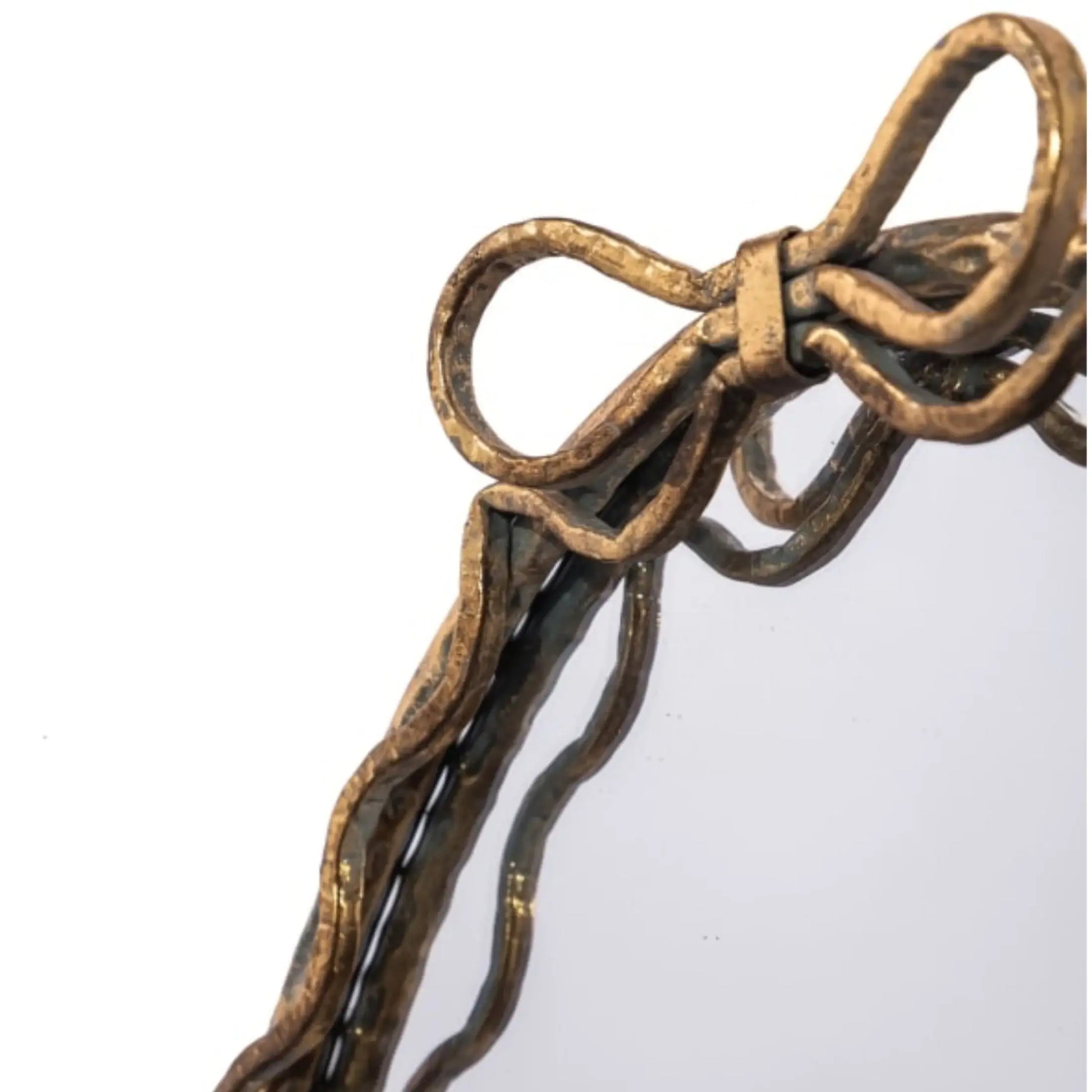 Bronze bow-shaped decorative item on a white background