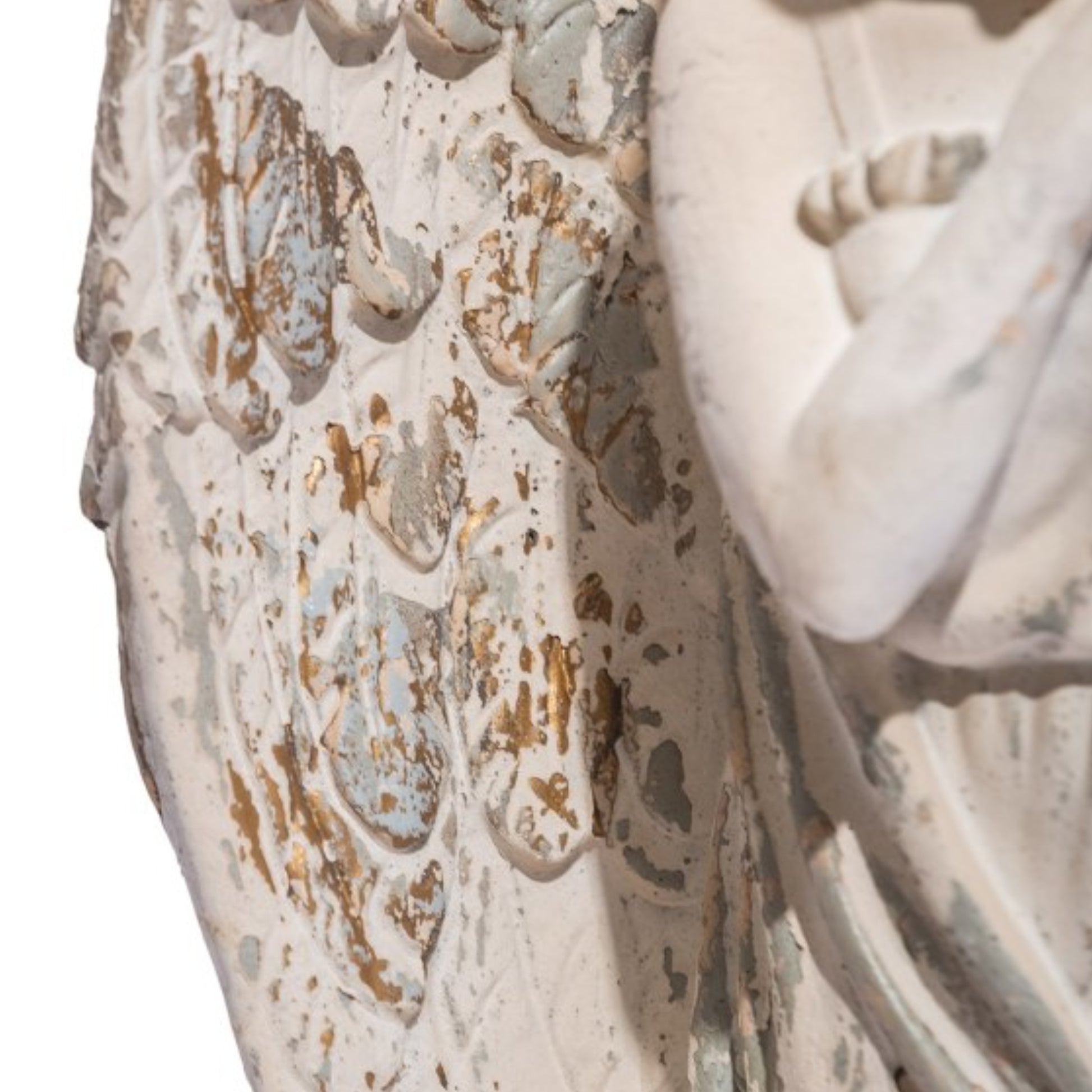 Close-up of a textured surface with intricate patterns and a statue in the background
