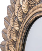 Decorative mirror with intricate gold and bronze frame on a white background