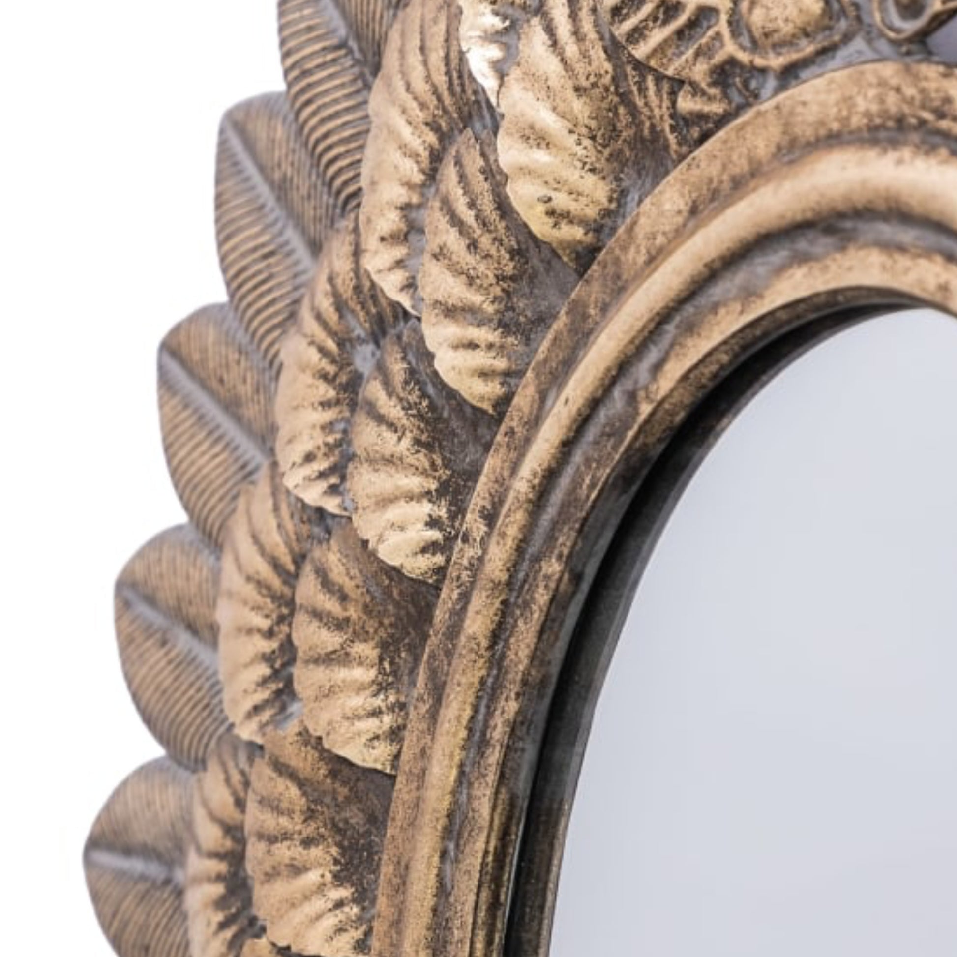 Decorative mirror with intricate gold and bronze frame on a white background