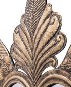 Close-up of ornate bronze leaf design on a white background