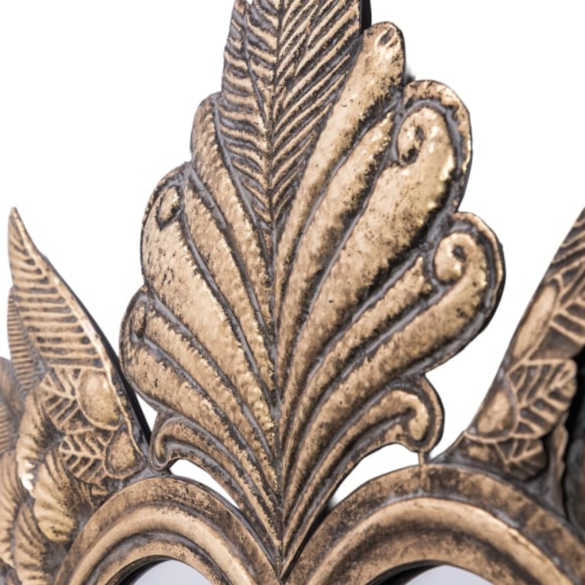 Close-up of ornate bronze leaf design on a white background