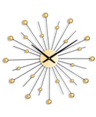 Decorative wall clock with gold accents on a white background