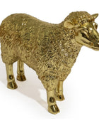 A metallic gold sheep figurine with a textured woolly body and polished finish, standing on a plain white background.