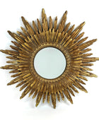 Gold sunburst mirror on a white background
