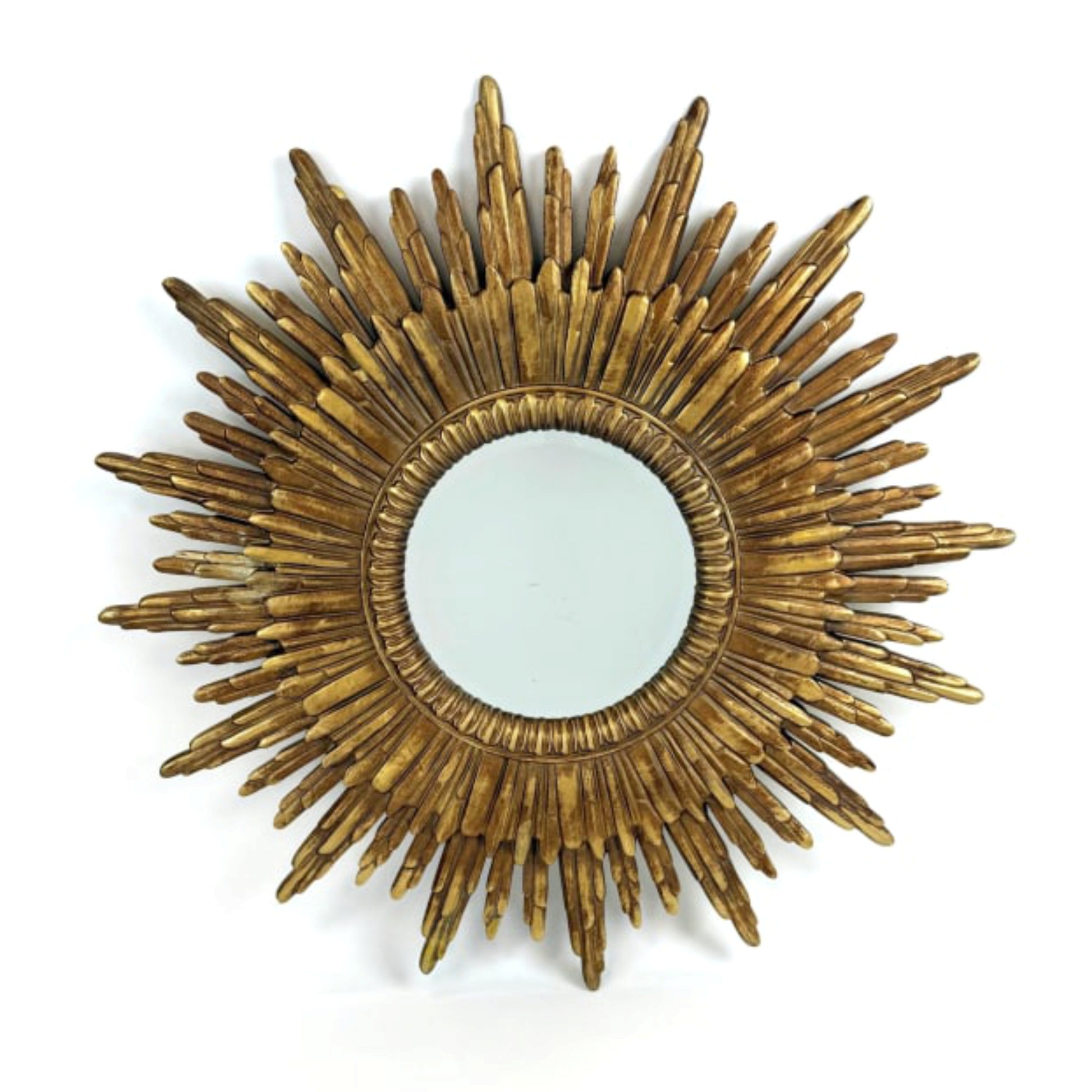 Gold sunburst mirror on a white background