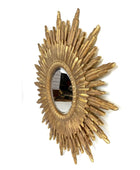 Gold sunburst mirror on a white background