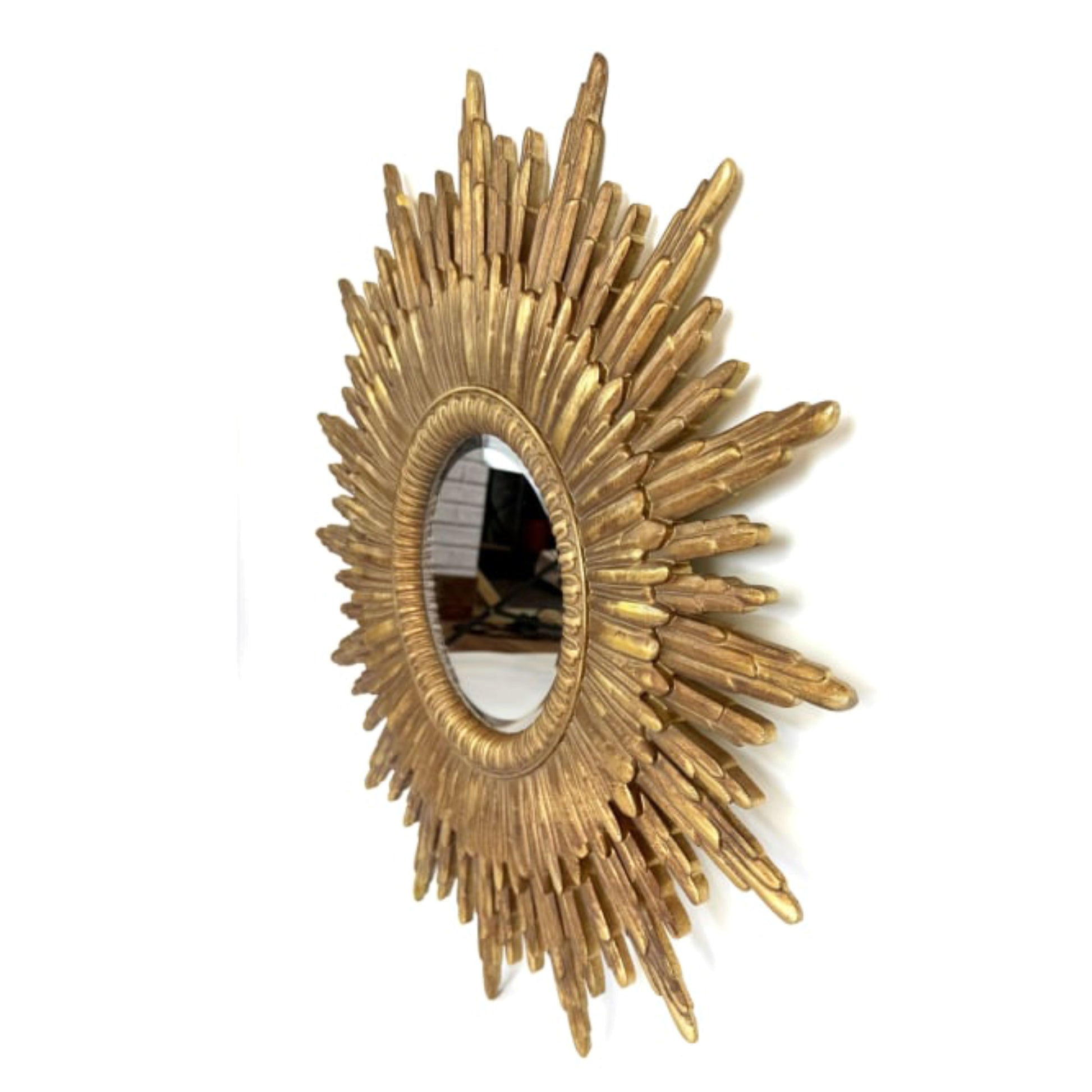 Gold sunburst mirror on a white background