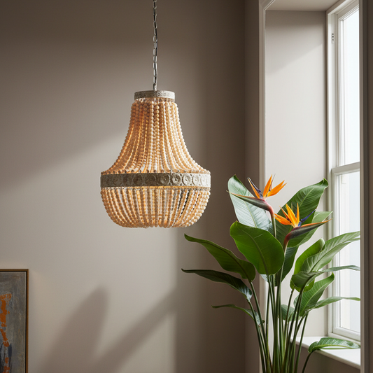 Beaded pendant light hanging in a room with a plant and window.