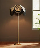 Decorative floor lamp with leopard print shade in a room with a window and plant.