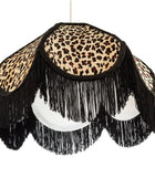 Leopard print lampshade with black fringes on a white background