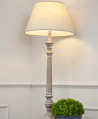 Floor lamp with a white shade in a room setting