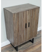 Wooden cabinet with slatted design on a wooden floor against a white wall